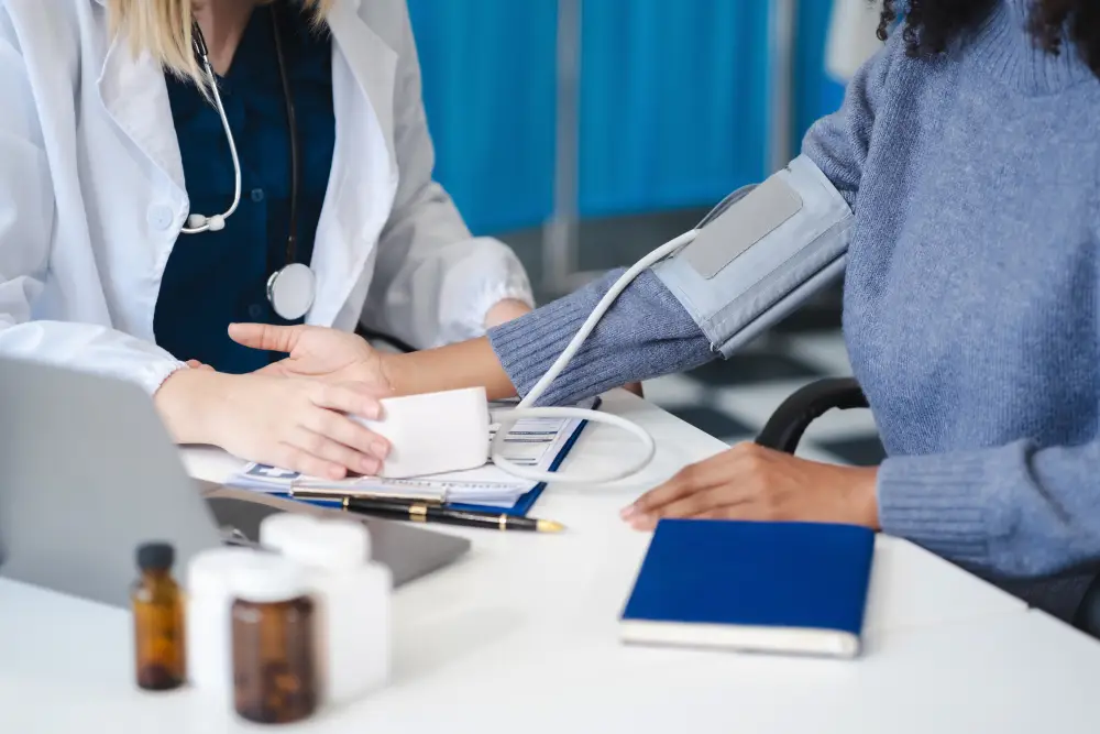 Doctor checking patient blood pressure during annual health screening at Complete Healthcare International, Orchard Singapore