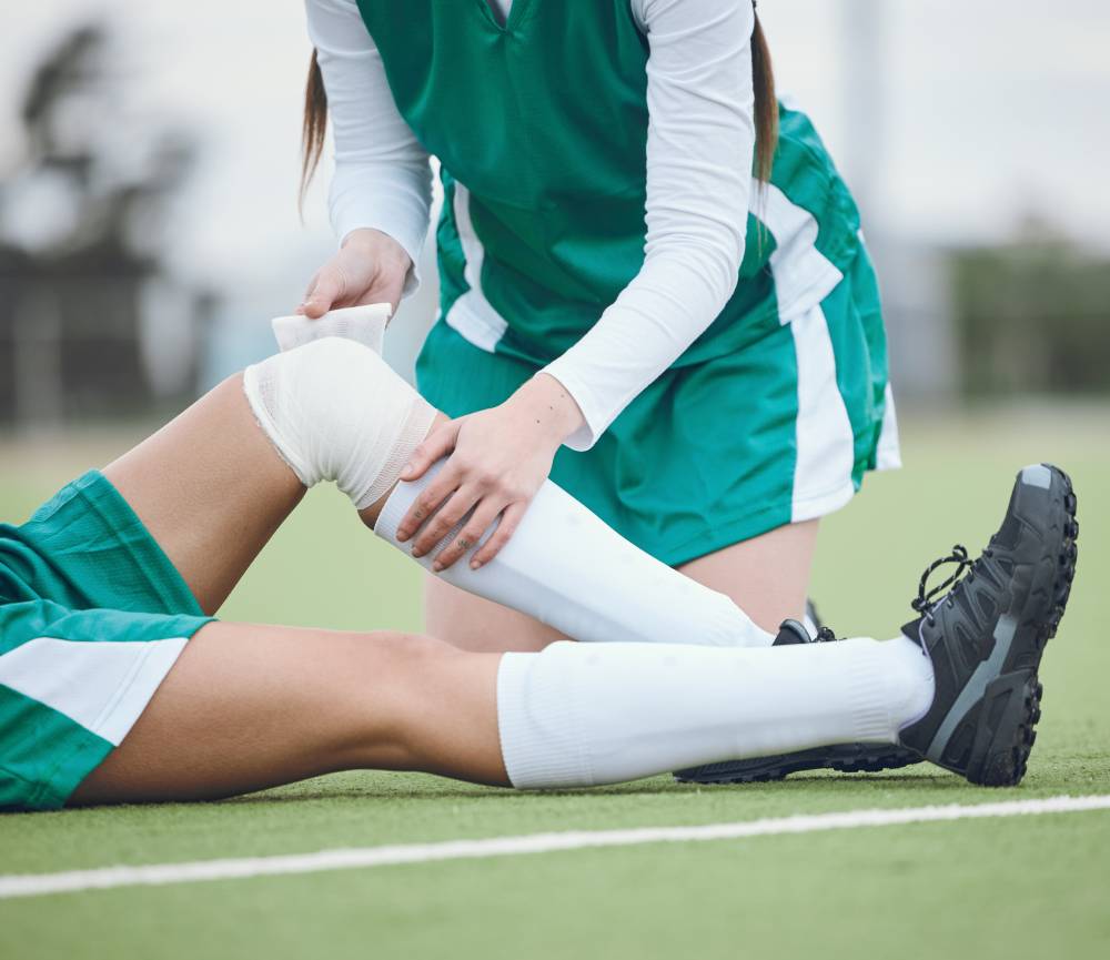 Medical professional assessing sports injury patient at Singapore clinic CHI