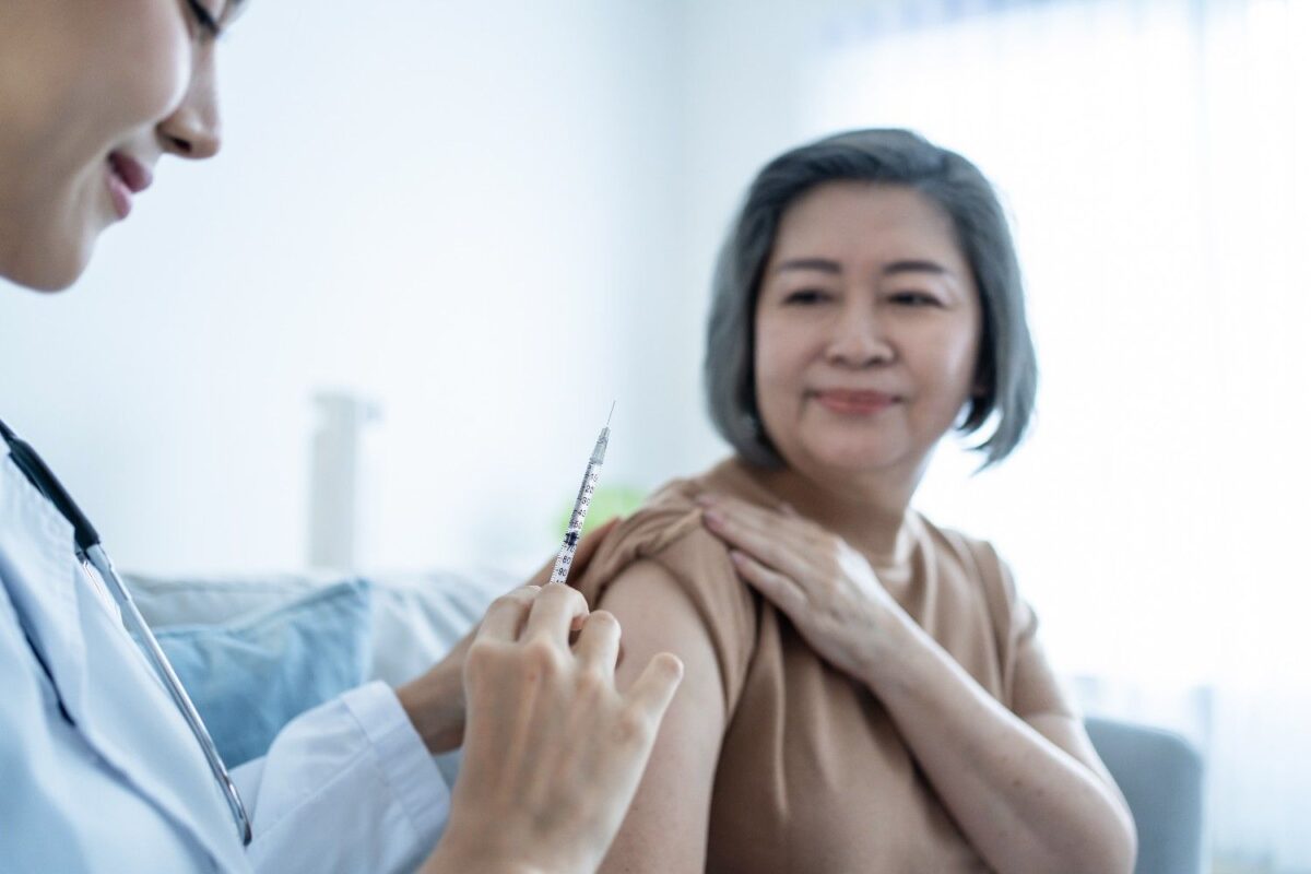 Elderly patient receiving shingles vaccination at CHI Health medical clinic in Orchard, Singapore